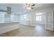 Open kitchen featuring white cabinetry, a sleek range hood, and luxury vinyl plank flooring at 4209 N 48Th Dr, Phoenix, AZ 85031