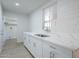 Bright kitchen featuring white cabinets, stainless steel sink and faucet, and granite countertop at 4209 N 48Th Dr, Phoenix, AZ 85031