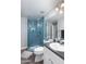 Stylish bathroom featuring a glass-enclosed shower with blue tiling and modern fixtures at 4343 N 21St St # 213, Phoenix, AZ 85016