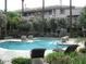 Community pool area offers a relaxing retreat with lounge seating, lush landscaping, and serene fountain features at 4343 N 21St St # 213, Phoenix, AZ 85016