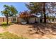 Backyard featuring mature trees, a well-kept lawn, and the home's exterior at 45 Leisure World -- # 45, Mesa, AZ 85206