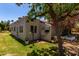 Backyard showing the house exterior, manicured lawn, trees, and a bird feeder at 45 Leisure World -- # 45, Mesa, AZ 85206