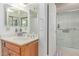Bathroom featuring a sink with wood cabinets, neutral countertop and a glass enclosed shower at 45 Leisure World -- # 45, Mesa, AZ 85206