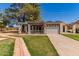 Charming home featuring a well-manicured lawn, covered patio, and an attached two-car garage at 45 Leisure World -- # 45, Mesa, AZ 85206