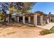 Front yard with covered patio featuring columns and a neutral facade at 45 Leisure World -- # 45, Mesa, AZ 85206