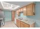 Well-lit kitchen with wood cabinets, white appliances, and granite countertops at 45 Leisure World -- # 45, Mesa, AZ 85206