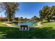 A tranquil neighborhood pond offers serene views and lush green surroundings at 45 Leisure World -- # 45, Mesa, AZ 85206