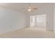 Spacious living room with neutral carpeting and a ceiling fan at 45 Leisure World -- # 45, Mesa, AZ 85206