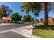 Pleasant street view featuring well-kept lawns and houses with desert landscaping at 45 Leisure World -- # 45, Mesa, AZ 85206