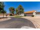 Serene street view showcasing well-maintained homes and lush landscaping on a sunny day at 45 Leisure World -- # 45, Mesa, AZ 85206
