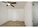 Bright bedroom featuring tile floors, a ceiling fan, and multiple closets at 5038 N 20Th Ave, Phoenix, AZ 85015
