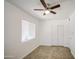Cozy bedroom featuring a window, closet, ceiling fan, and tile flooring at 5038 N 20Th Ave, Phoenix, AZ 85015