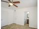 Bedroom featuring tile floors, a ceiling fan, and access to an ensuite bathroom at 5038 N 20Th Ave, Phoenix, AZ 85015