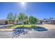 Quaint home with mature landscaping, a paved driveway, and a sunlit facade at 5038 N 20Th Ave, Phoenix, AZ 85015