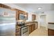 Modern kitchen featuring stainless steel appliances and granite countertops, with tiled floors at 5038 N 20Th Ave, Phoenix, AZ 85015