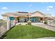 Beautiful backyard view featuring a patio, outdoor dining, and manicured lawn at 5221 N Tuthill Rd, Litchfield Park, AZ 85340
