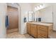 Bathroom with a shower, tile floors, and a vanity with wood cabinets and counterspace at 5221 N Tuthill Rd, Litchfield Park, AZ 85340