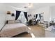 Bright bedroom with ceiling fan, large window, and mirrored closet doors at 5221 N Tuthill Rd, Litchfield Park, AZ 85340