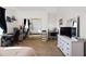 Sunlit bedroom with large mirrored closet doors and dual desks at 5221 N Tuthill Rd, Litchfield Park, AZ 85340