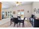 An open dining room with stylish dark wood table and chairs near the outdoor space at 5221 N Tuthill Rd, Litchfield Park, AZ 85340