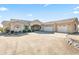 A sprawling home with desert landscaping, a circular driveway, and a convenient three-car garage at 5221 N Tuthill Rd, Litchfield Park, AZ 85340