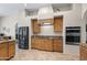 Bright kitchen featuring wood cabinetry, granite countertops, and stainless steel appliances at 5221 N Tuthill Rd, Litchfield Park, AZ 85340