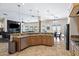 Open-concept kitchen offering wood cabinets, granite countertops, and stainless-steel appliances at 5221 N Tuthill Rd, Litchfield Park, AZ 85340