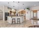 Well-appointed kitchen features granite countertops, stainless appliances, and a central island with bar seating at 5221 N Tuthill Rd, Litchfield Park, AZ 85340
