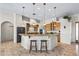 Kitchen with wood cabinets, granite countertops, stainless steel appliances, and a breakfast bar at 5221 N Tuthill Rd, Litchfield Park, AZ 85340