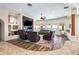 Open-concept living room with natural light, comfortable seating, and built-in entertainment center at 5221 N Tuthill Rd, Litchfield Park, AZ 85340