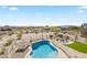 Breathtaking views of an in-ground pool and desert landscape from an elevated vantage point at 5221 N Tuthill Rd, Litchfield Park, AZ 85340