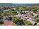 The aerial captures a serene neighborhood featuring well-kept homes, private pools, and an eco-friendly solar panel setup at 5353 W Dublin Ct, Chandler, AZ 85226