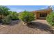 Well-maintained backyard with gravel landscaping, mature trees, and a charming brick-lined garden area at 5353 W Dublin Ct, Chandler, AZ 85226
