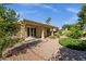 Inviting covered patio with gravel landscaping and lush greenery creates a serene backyard oasis at 5353 W Dublin Ct, Chandler, AZ 85226