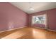 Airy bedroom with wood floors, a ceiling fan, and ample natural light from the window at 5353 W Dublin Ct, Chandler, AZ 85226