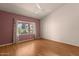 Bright bedroom with hardwood floors, ceiling fan, and large window offering natural light at 5353 W Dublin Ct, Chandler, AZ 85226