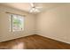 Bedroom with hardwood floors, ceiling fan, and a bright window at 5353 W Dublin Ct, Chandler, AZ 85226