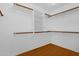 Walk-in closet with built-in shelves and wooden rods for ample storage at 5353 W Dublin Ct, Chandler, AZ 85226