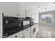 Well-equipped kitchen with granite countertops, modern appliances, and stylish white cabinets at 5353 W Dublin Ct, Chandler, AZ 85226