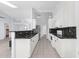 Galley kitchen boasts white cabinets, black granite countertops, and stainless steel appliances at 5353 W Dublin Ct, Chandler, AZ 85226