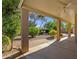 Covered patio offers beautiful views of the landscaped backyard with mature trees and privacy at 5353 W Dublin Ct, Chandler, AZ 85226