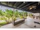 Covered patio has a comfortable outdoor sofa, ceiling fan, and garden view at 5607 N 23Rd Ave, Phoenix, AZ 85015