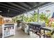 This covered patio features multiple grills and a sink for outdoor cooking at 5607 N 23Rd Ave, Phoenix, AZ 85015