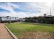 The backyard with a grassy lawn, gravel area, swing set, and RV parking, ideal for outdoor activities and relaxation at 5607 N 23Rd Ave, Phoenix, AZ 85015