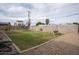 Expansive backyard featuring a lush lawn, gravel area, and a swing set, perfect for Gathering fun and outdoor enjoyment at 5607 N 23Rd Ave, Phoenix, AZ 85015
