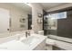 Bathroom features a large mirror, modern vanity, and shower with dark tiling at 5607 N 23Rd Ave, Phoenix, AZ 85015