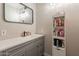 This bathroom has a modern gray vanity with bright lighting at 5607 N 23Rd Ave, Phoenix, AZ 85015