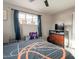 This bedroom has gray-tone walls and a window with blue curtains at 5607 N 23Rd Ave, Phoenix, AZ 85015