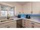 Updated kitchen featuring white cabinets, sleek countertops, and modern stainless steel appliances at 5607 N 23Rd Ave, Phoenix, AZ 85015