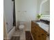 Well-lit bathroom with a modern vanity, toilet, shower with dark tile, and a plant for added freshness at 6546 N 71St Ave, Glendale, AZ 85303